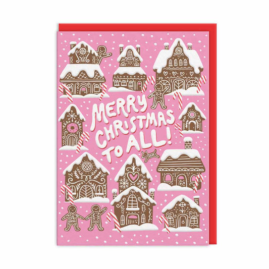 Pink Christmas card with Gingerbread house illustrations and icing style text that reads Merry Christmas To All